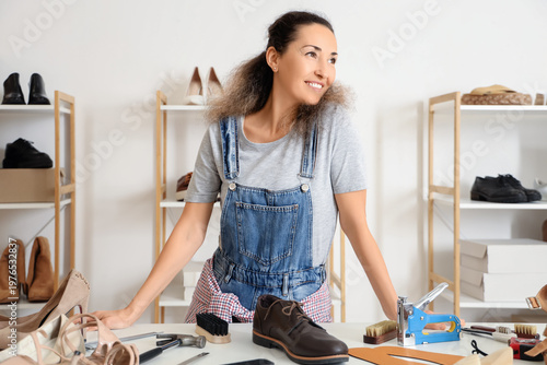 Female shoemaker at table i...
