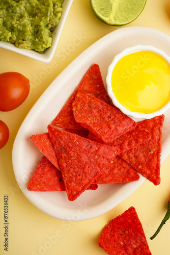 Plate with red nachos, sauc...