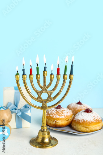 Menorah with burning candle...