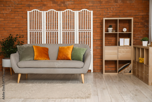 Cozy grey sofa with cushion...