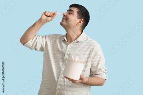 Young man with nasal drops ...