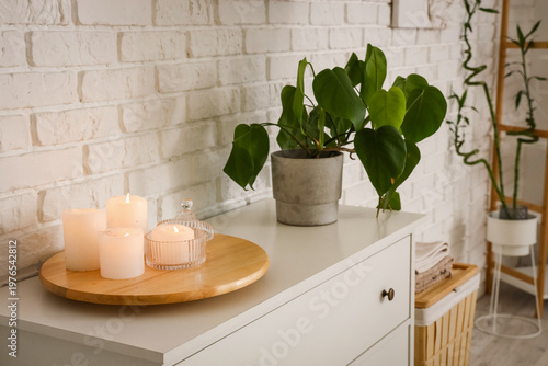 Burning candles with plant ...