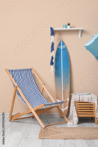 Deckchair with surfboard in...