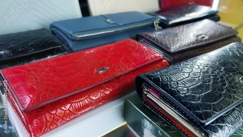 Luxury Leather Wallets Display in Accessories Store | Women's Crocodile Embossed Purses Collection in Red, Black and Blue | Close-Up Retail Showcase