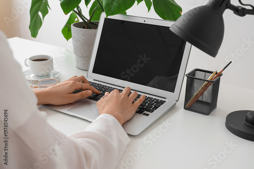 Woman working on laptop at ...