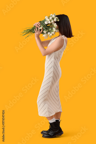 Beautiful Asian woman holdi...