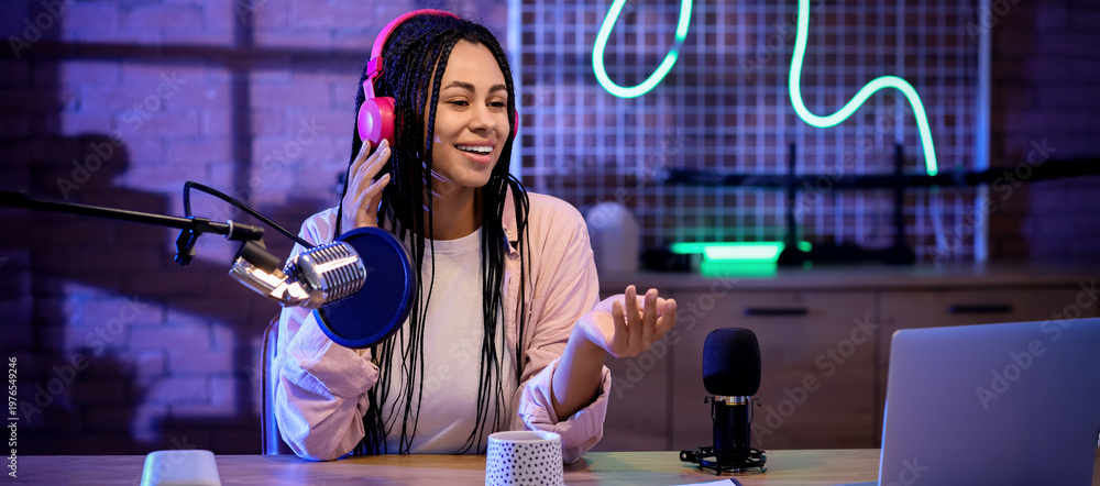 Εκτύπωση καμβά Female African-American radio presenter recording broadcast at table in studio