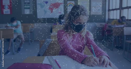 Vertical video: Writing after sheet cue, masked kid in pink top in class using green pencil overlay