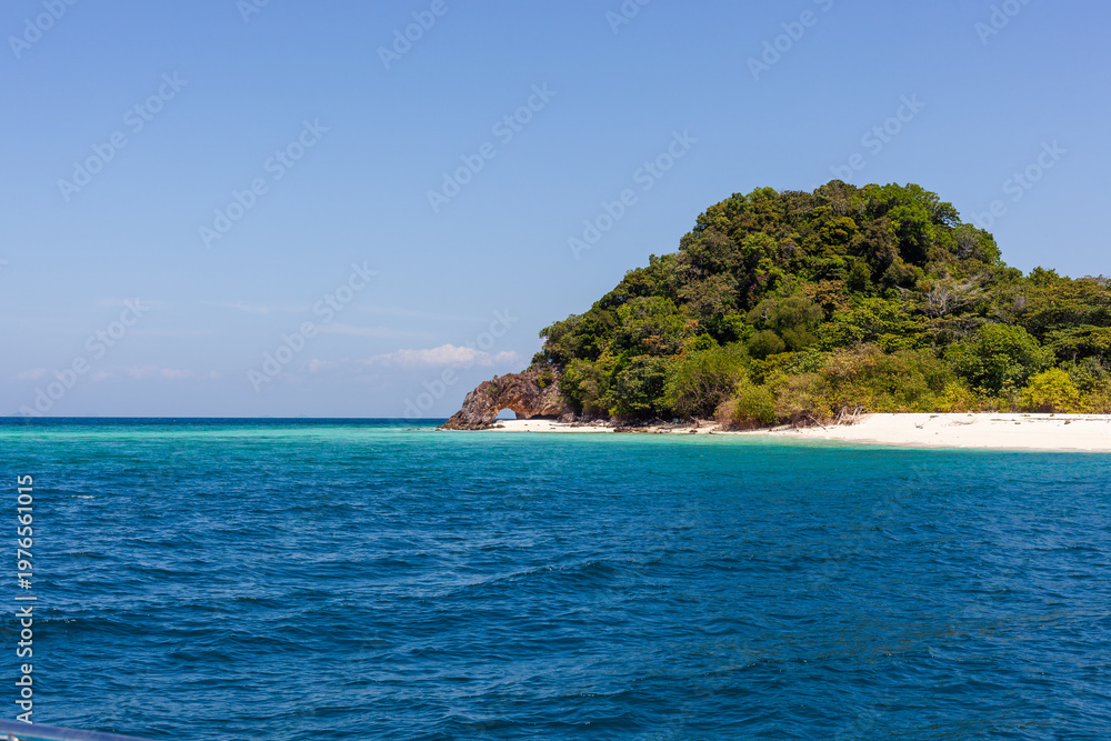 Fototapeta premium Ko Chuku Islet in Tarutao National Marine Park. Tropical green island with clear blue waters.