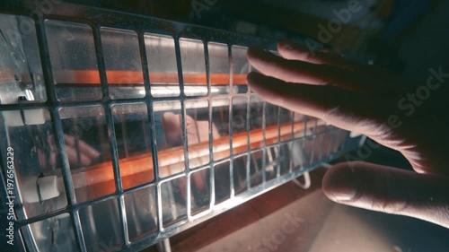 Hand Warming Near Infrared Electric Heater with Orange Glow | Space Heater Close-Up in Dark Room | Heat and Light at Night in Winter
