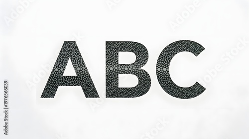 ABC letters on white background: Bold letters spelling ABC stand out in textured dark gray against a stark background, minimalist design for educational and branding purposes.