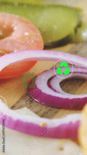 Vertical video: Camera panning, patty entering, onion ring visible, eco icons over food ads