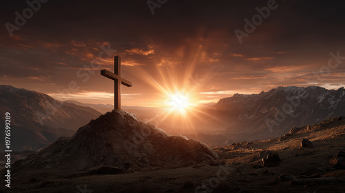 Cross on mountain at sunset with bright light over valley and dark sky