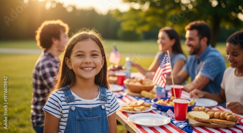 Smiling Girl Celebrating Fourth of July with Family Picnic Outdoors
