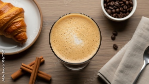 Morning delight cappuccino with a delicious croissant, cinnamon sticks