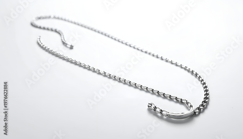 Silver necklace on white background.