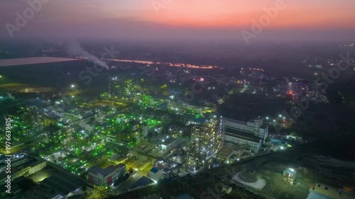Drone shot of industrial factory at night with glowing lights in Nagda India
