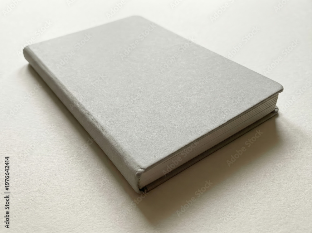 Fototapeta premium Plain Light Gray Hardcover Notebook on White Surface journal writing