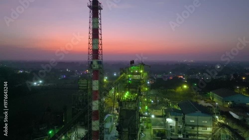 Drone shot of industrial factory at night with glowing lights in Nagda India