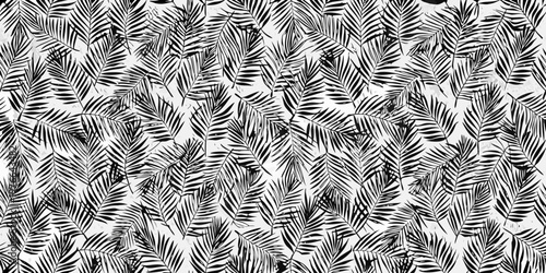 A seamless pattern of detailed tropical palm leaves in black and white