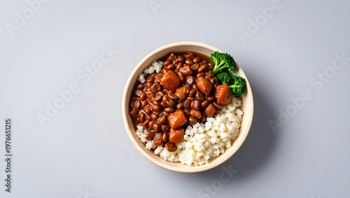 Isolated feijoada in a round bowl with farofa and kale, set on a neutral gray background for product display, bright and clear lighting with detailed shadows and textures