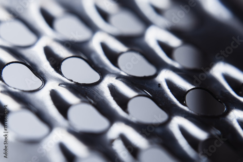 Foto High angle macro shot of a stainless steel cheese grater surface with round hole