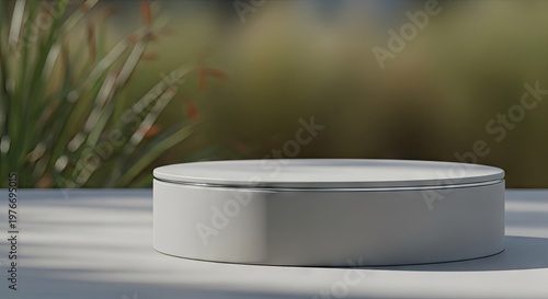 A white cylindrical object sits on a table outdoors in natural light