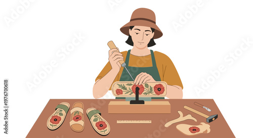 Artisan crafting floral design on wooden item, tools and sandals on table