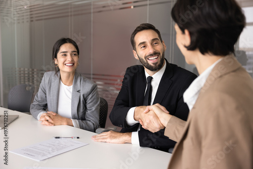 Slika na platnu Diverse businesspeople, client and company manager handshake after signing contract, finalizing successful commercial deal in office conference room during business meeting