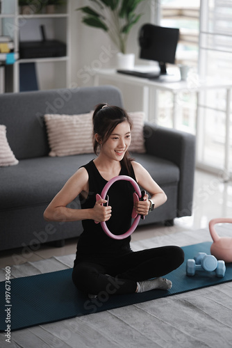 Asian woman exercises in her living room at home to promote vitality