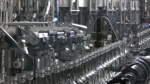 Clear glass bottles transfer on Automated conveyor systems industrial automation for package. Empty glass bottles on the conveyor. Factory for bottling alcoholic beverages