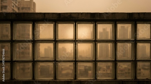 Grid of glass blocks reflecting a smoke tinted skyline in muted amber light, turning architecture into a metaphor for filtered vision, airborne particles, and contaminated urban atmosphere