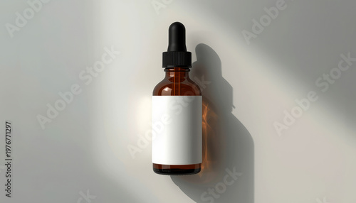 A brown glass bottle with a dropper lid and a white label on a plain surface