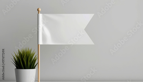 A small white flag stands next to a potted plant on a plain gray background