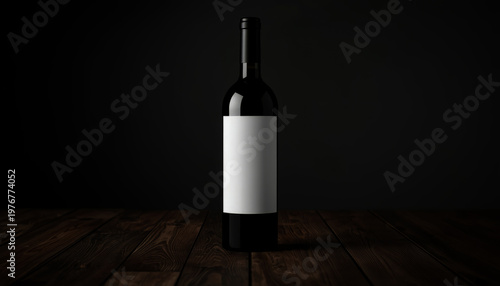 A wine bottle with a blank label stands on a wooden table against a dark background