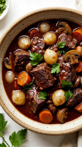 Top view of a hearty bowl filled with savory beef bourguignon stew featuring slow cooked meat, carrots, and mushrooms in a rich red wine sauce garnish with parsley. Generative AI.