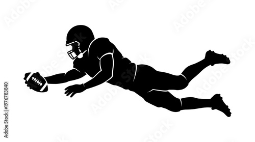 Silhouette of an American football player diving with the ball to score a touchdown in a dynamic action pose.