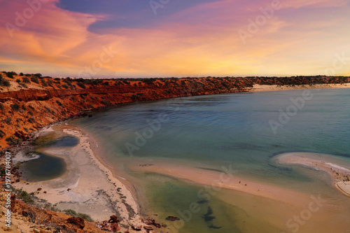 Skip Jack Point sunset over rugged coastal cliffs and sandy beach