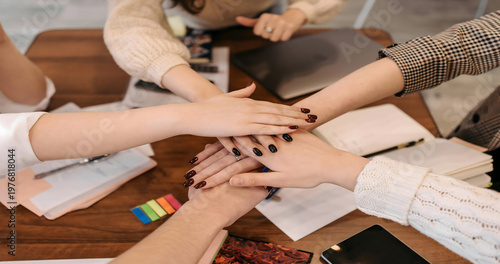 Canvas Print Diverse group of business people joining hands together in a gesture of teamwork and unity