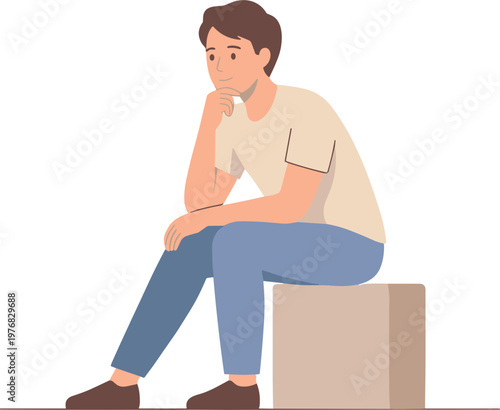 A man sits on a box looking thoughtful in an indoor setting.