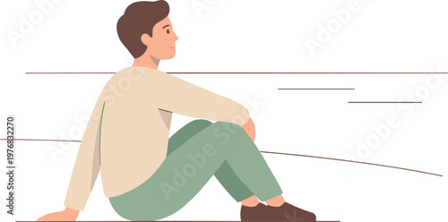 A man sits on a floor looking sideways in an indoor setting.