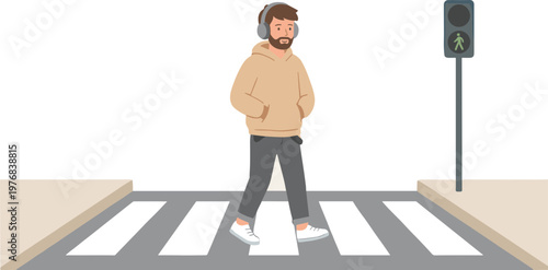 Man wearing headphones crossing street on pedestrian walkway in city