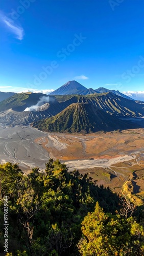 A serene mountain landscape with lush greenery and a clear blue sky