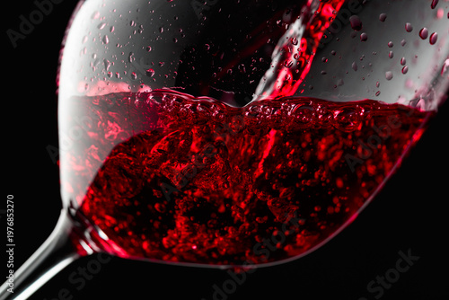 Cuadro en lienzo Red wine is poured into a glass.