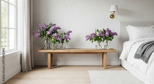A serene bedroom with a wooden bench and purple flowers