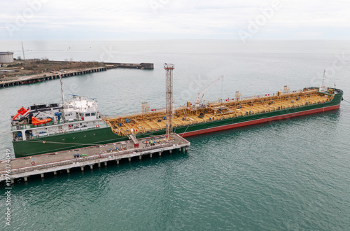 Fotografija Oil tanker docked at sea terminal, petroleum cargo transport, coastal industry, import export network, freight shipping infrastructure, drone panorama