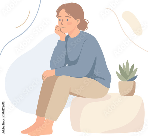 A woman sits on a rock crying next to a potted plant indoors