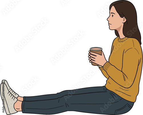 Woman sits on floor holding coffee cup in hands wearing casual clothes
