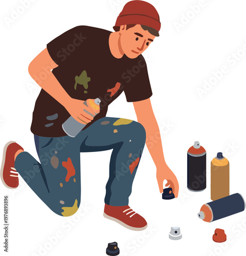 A young man crouches down holding a spray can painting graffiti.