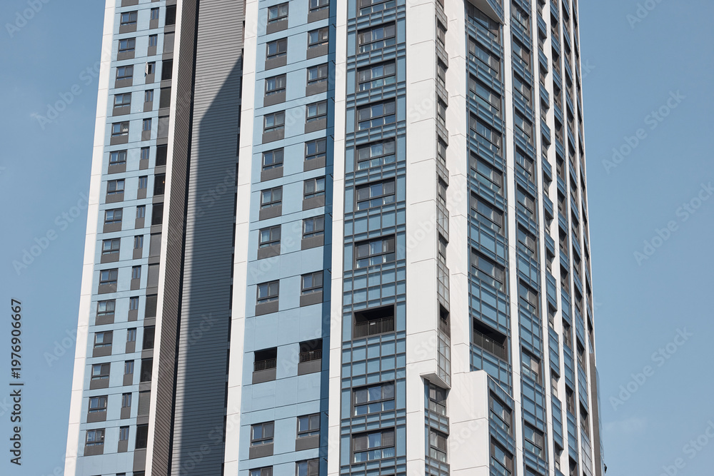 Fototapeta premium Close apartment tower facade under clear daylight
